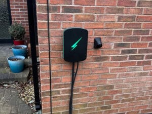 Electric vehicle charger on brick wall