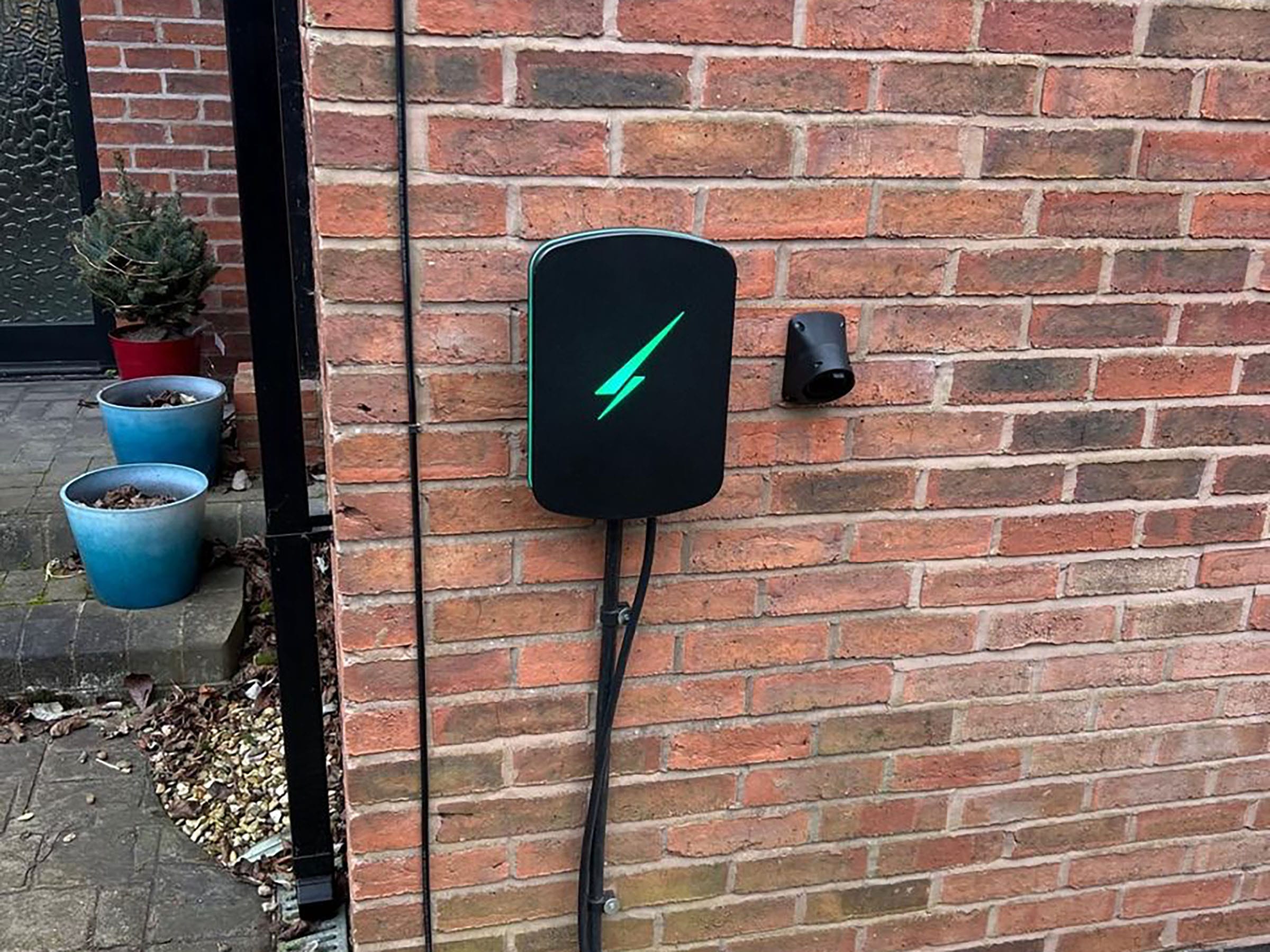Electric vehicle charger on brick wall