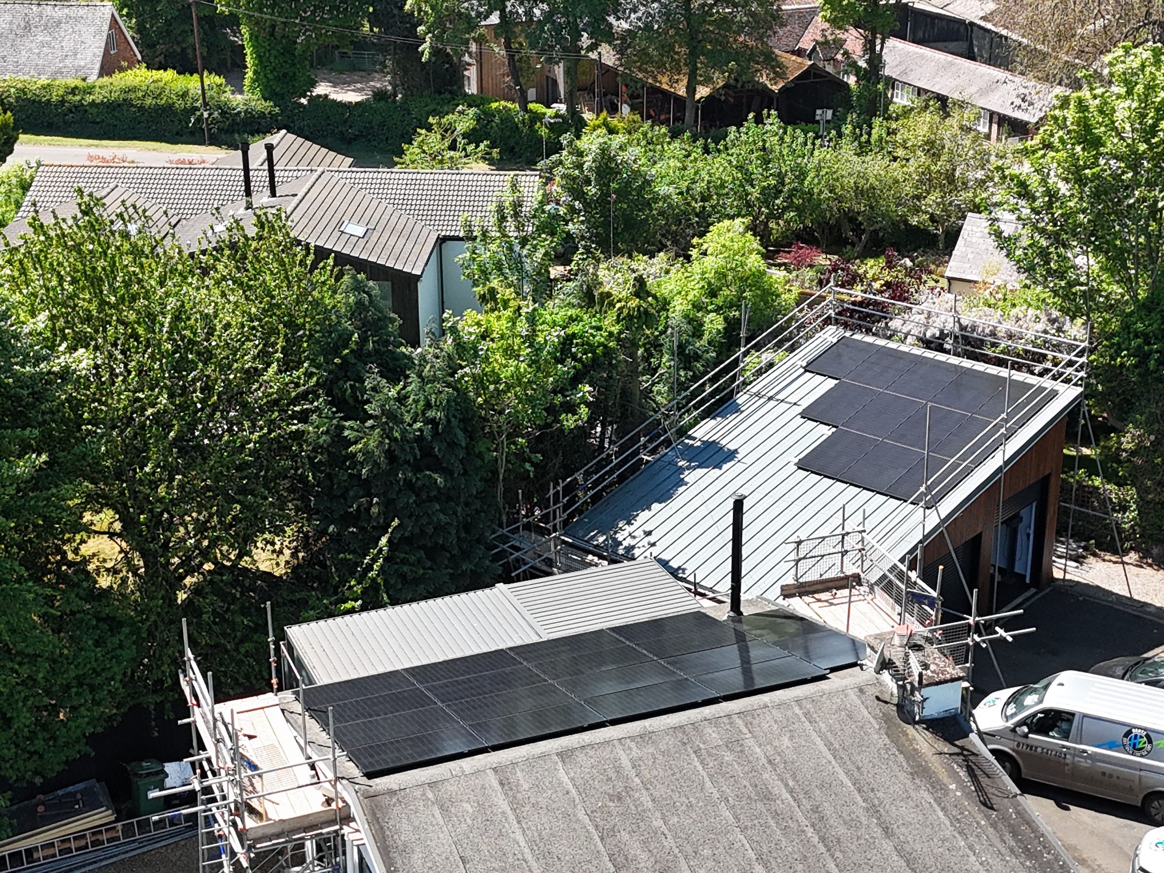 Rooftop solar panels on house in green neighbourhood.