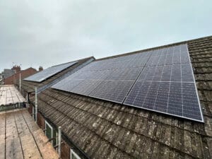 Rooftop solar panels installed on a cloudy day.