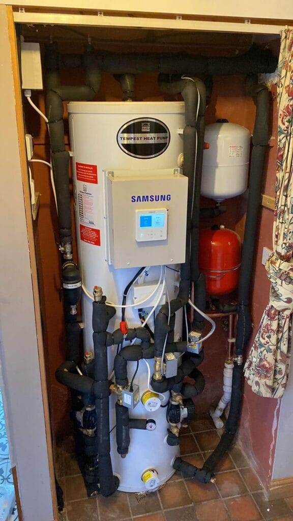 Heat pump system in utility room corner.