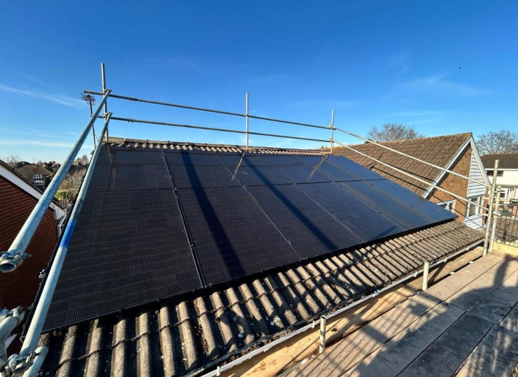 Solar panels on a rooftop under construction.