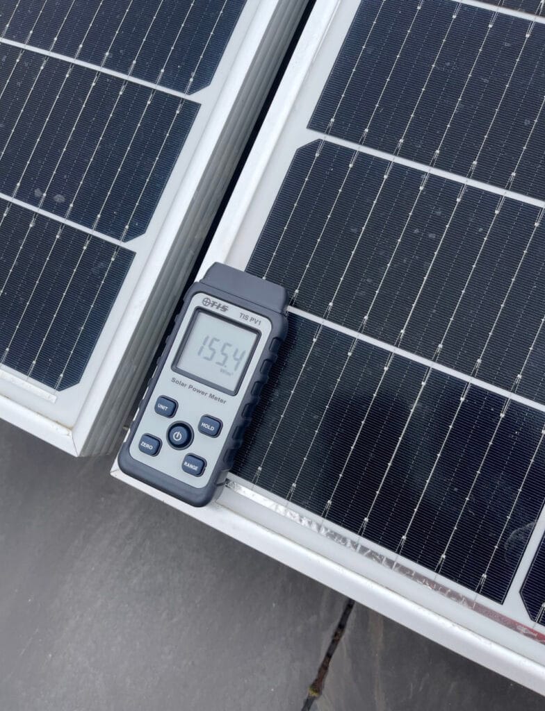 Solar panel measurement with power meter display.
