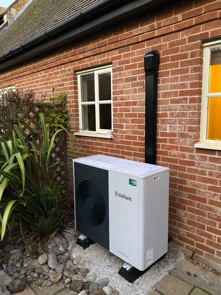 Outdoor air source heat pump installed by house.