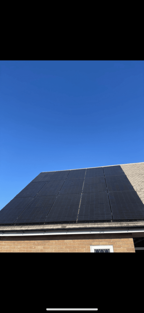 Rooftop solar panels on a brick house.