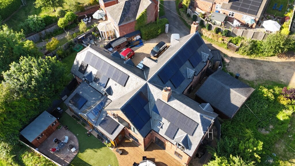 House with solar panels and garden from above.