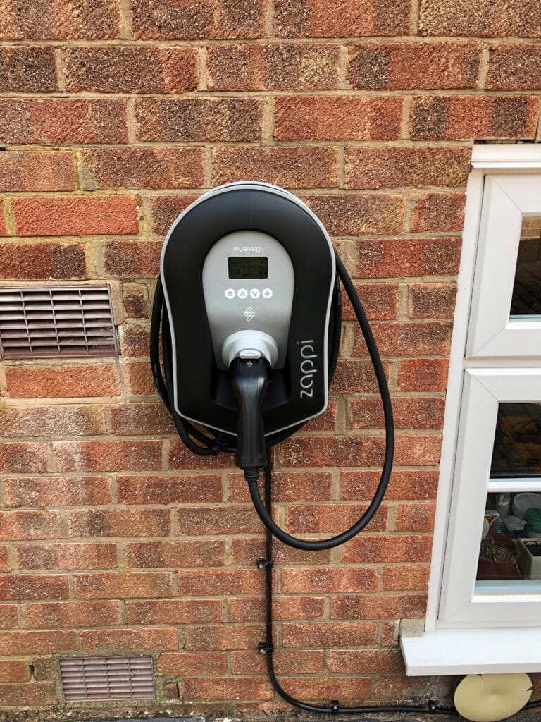 Wall-mounted electric vehicle charging point.