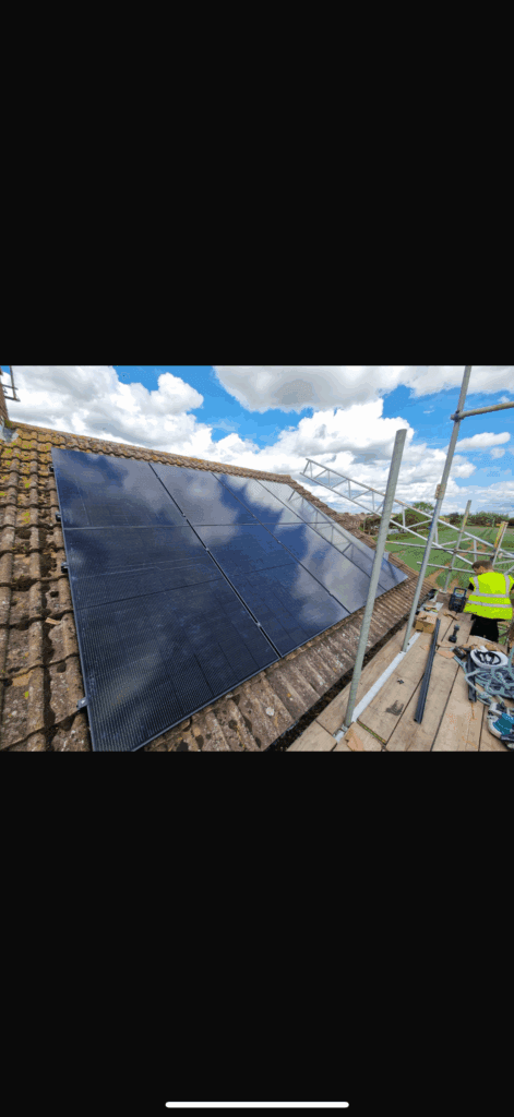 Solar panels installed on house roof with scaffolding.