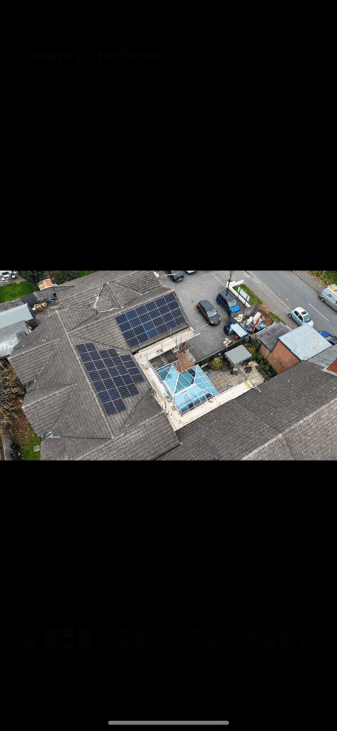 Aerial view of rooftops with solar panels.