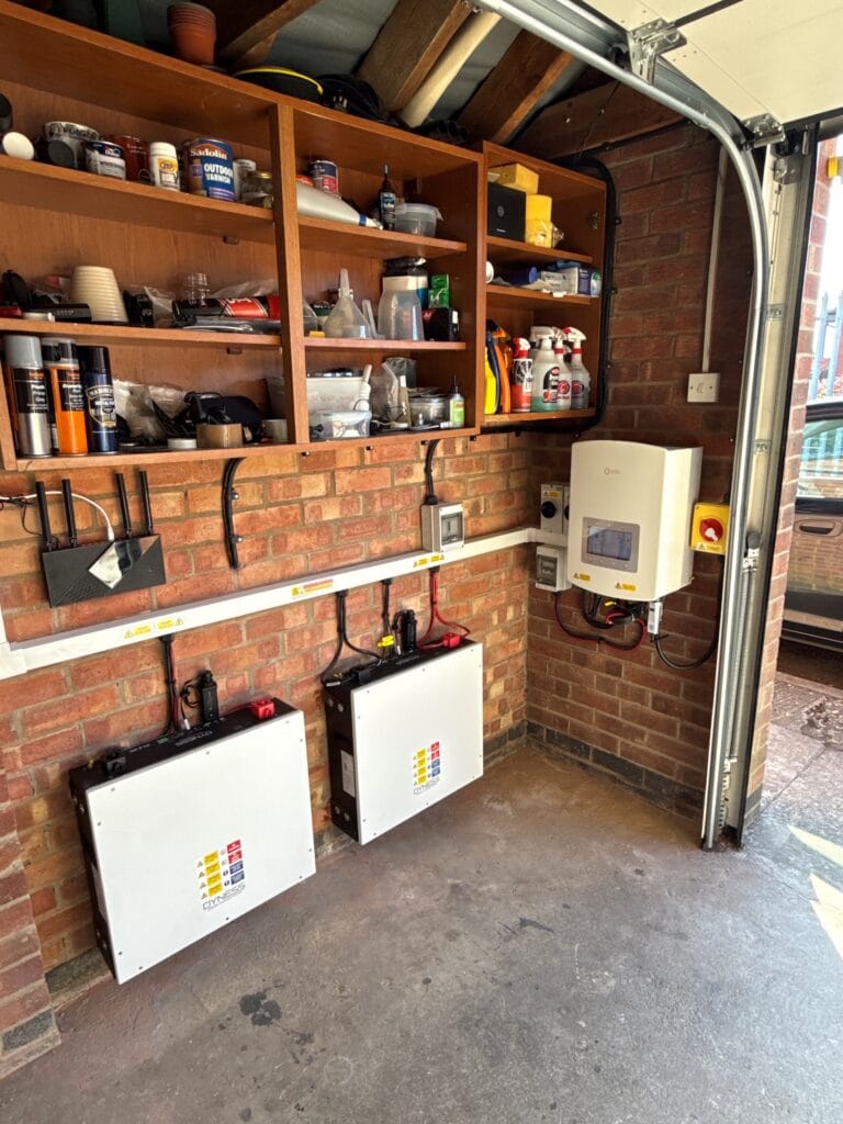 Garage with shelves and electrical boxes installed.