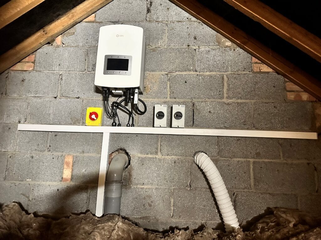 Solar inverter and electrical switches in attic installation.